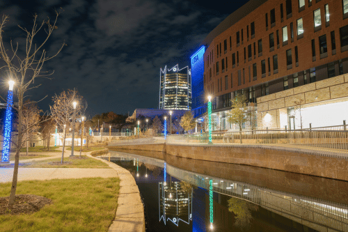 San Pedro I building at night with Frost Building in the background