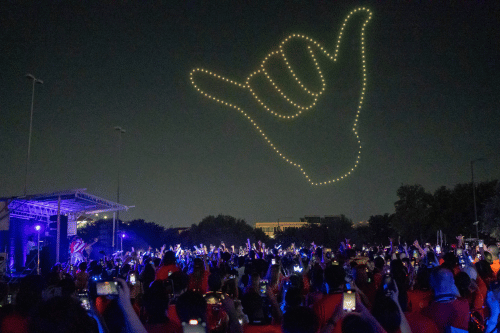 Midnight Light event with drone Rowdy Hand symbol in night sky