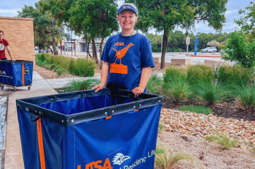 female student with a Housing and Residence Life cart