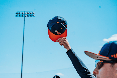 UTSA cap being held in the air