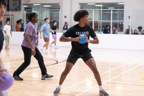 Students on basketball court playing dodgeball