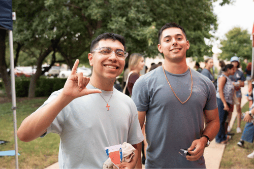 two students with their Birds Up