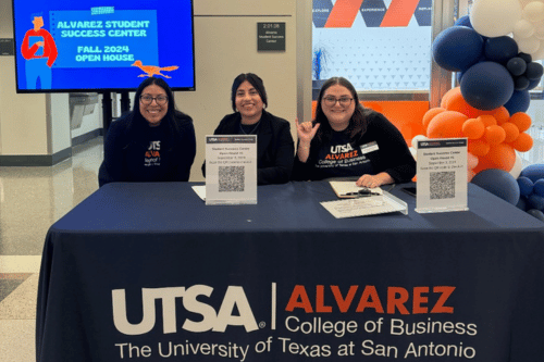 three people tabling in front of the Alvarez Student Success Center