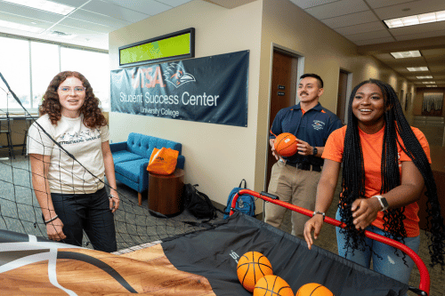 students playing indoor arcade style basketball game