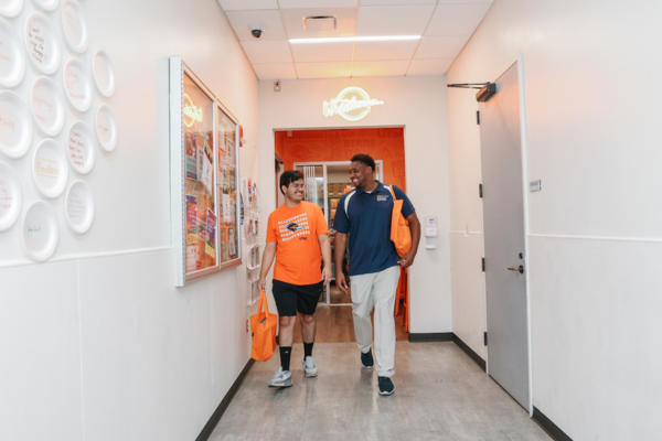 two students walk out of the Roadrunner pantry with supplies