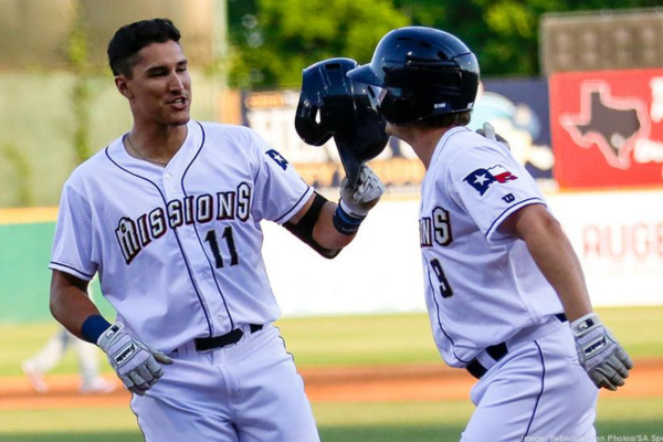 Two SA Missions baseball players high fiving