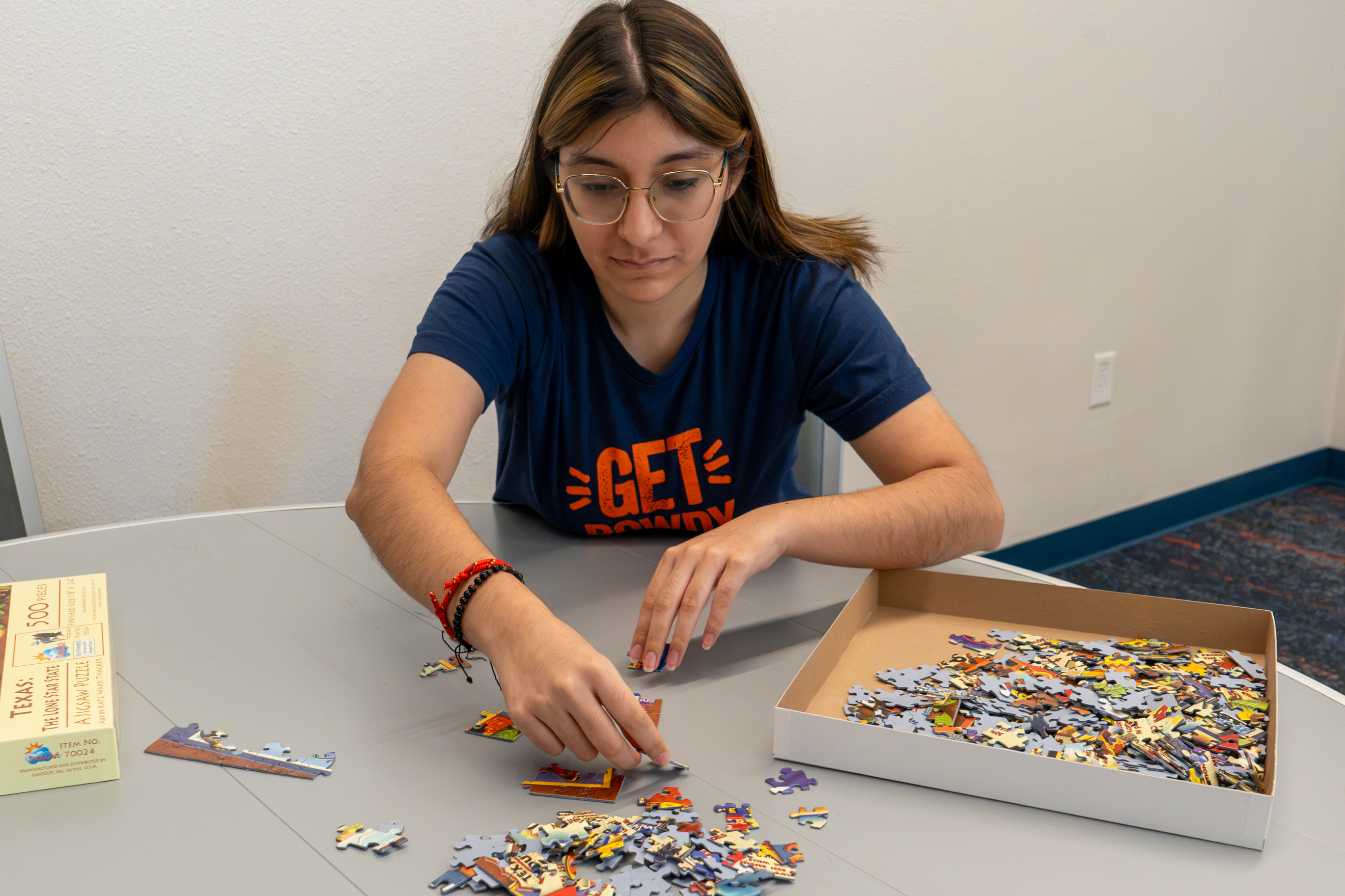 student putting a jigsaw puzzle together