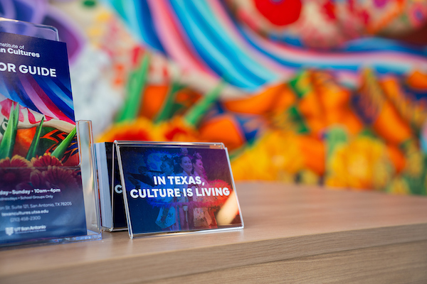 Institute of Texan Cultures welcome desk with "In Texas, Culture is Living" sign