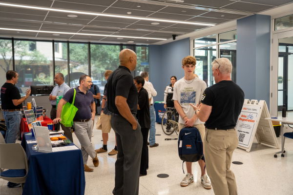 people tabling and students browsing