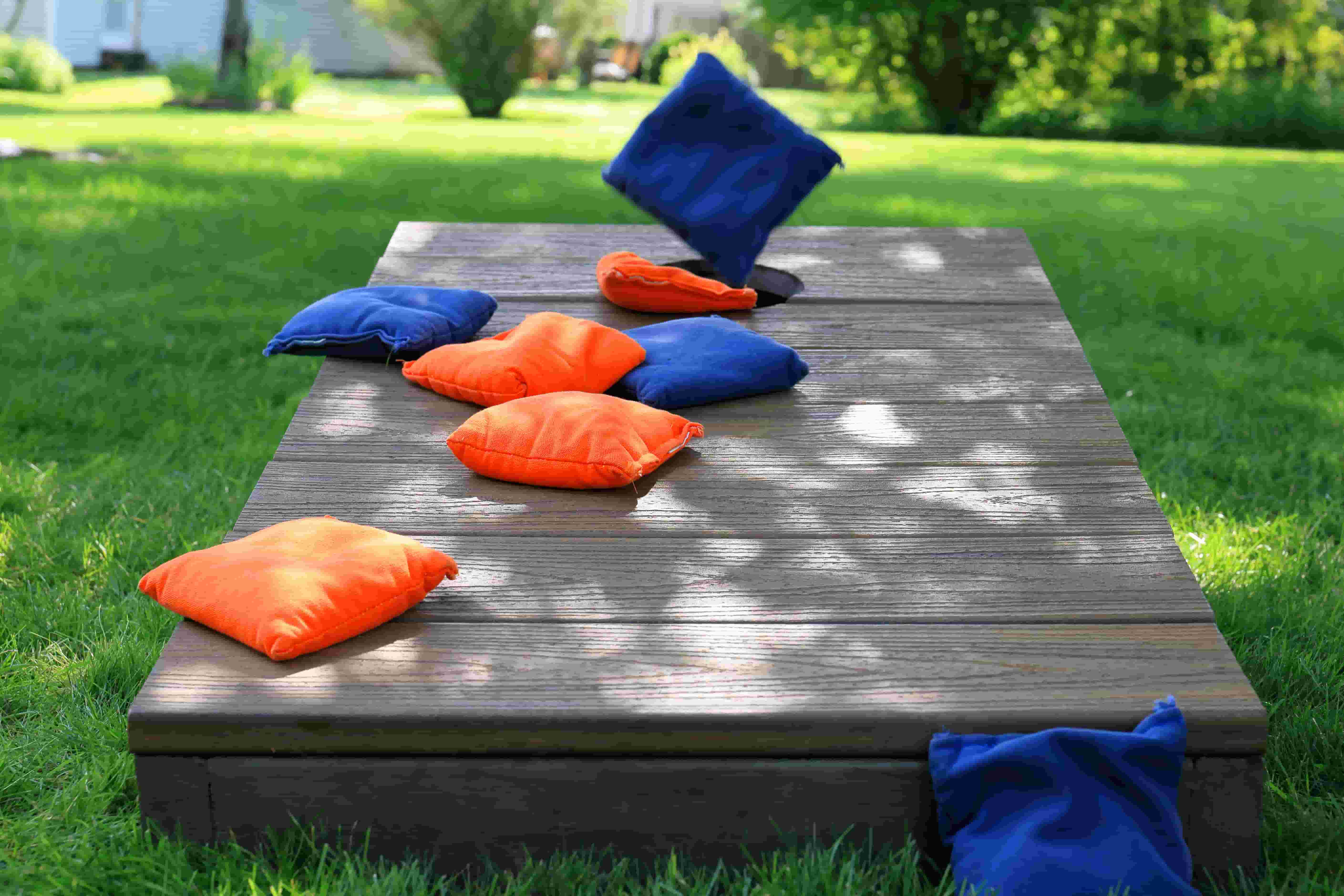 cornhole with blue and orange bean bags