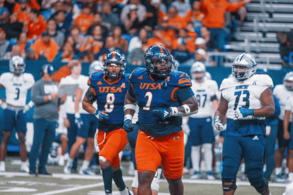 two UTSA football players on the field