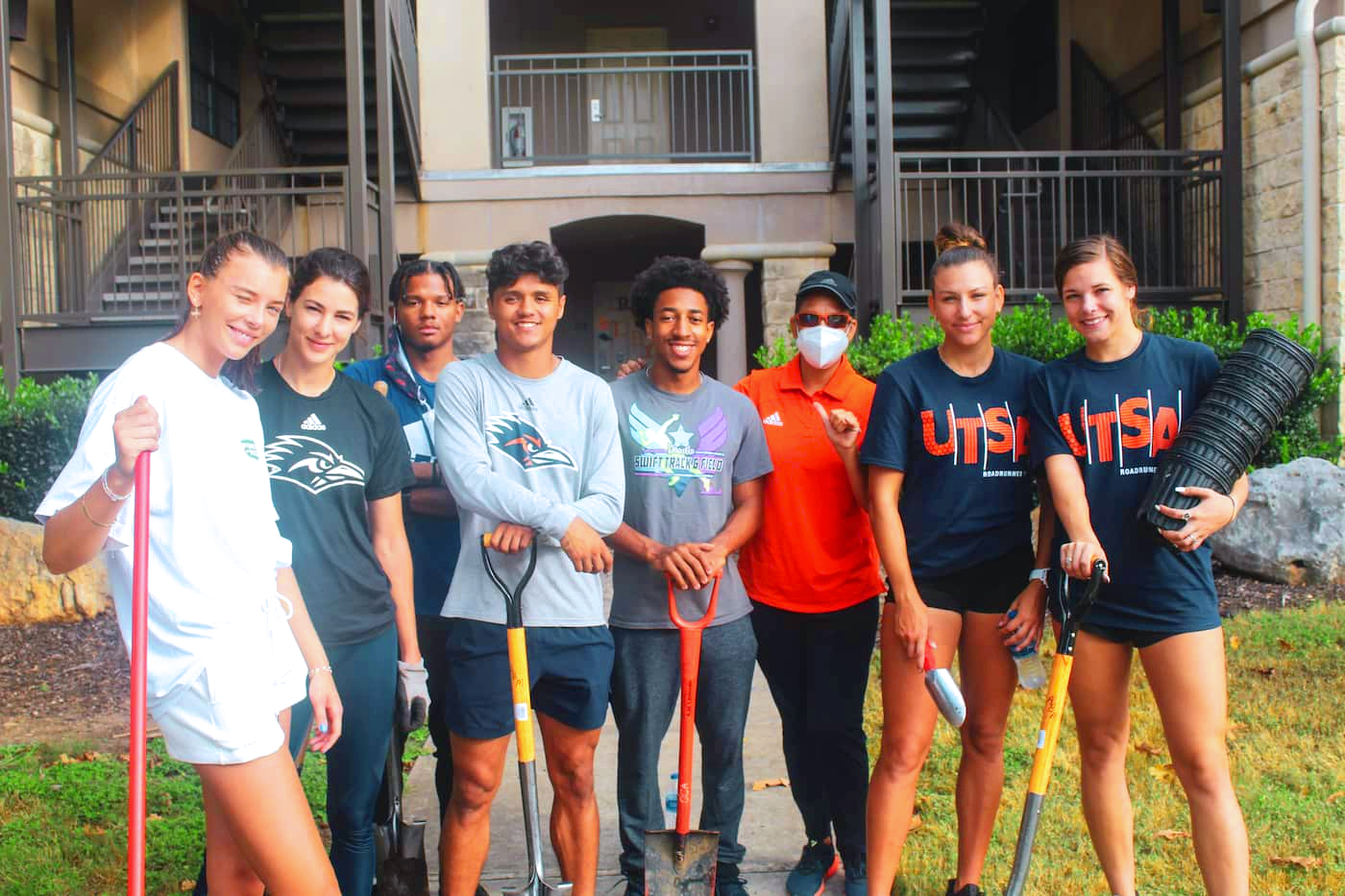 Students at a Service Project holding shovels
