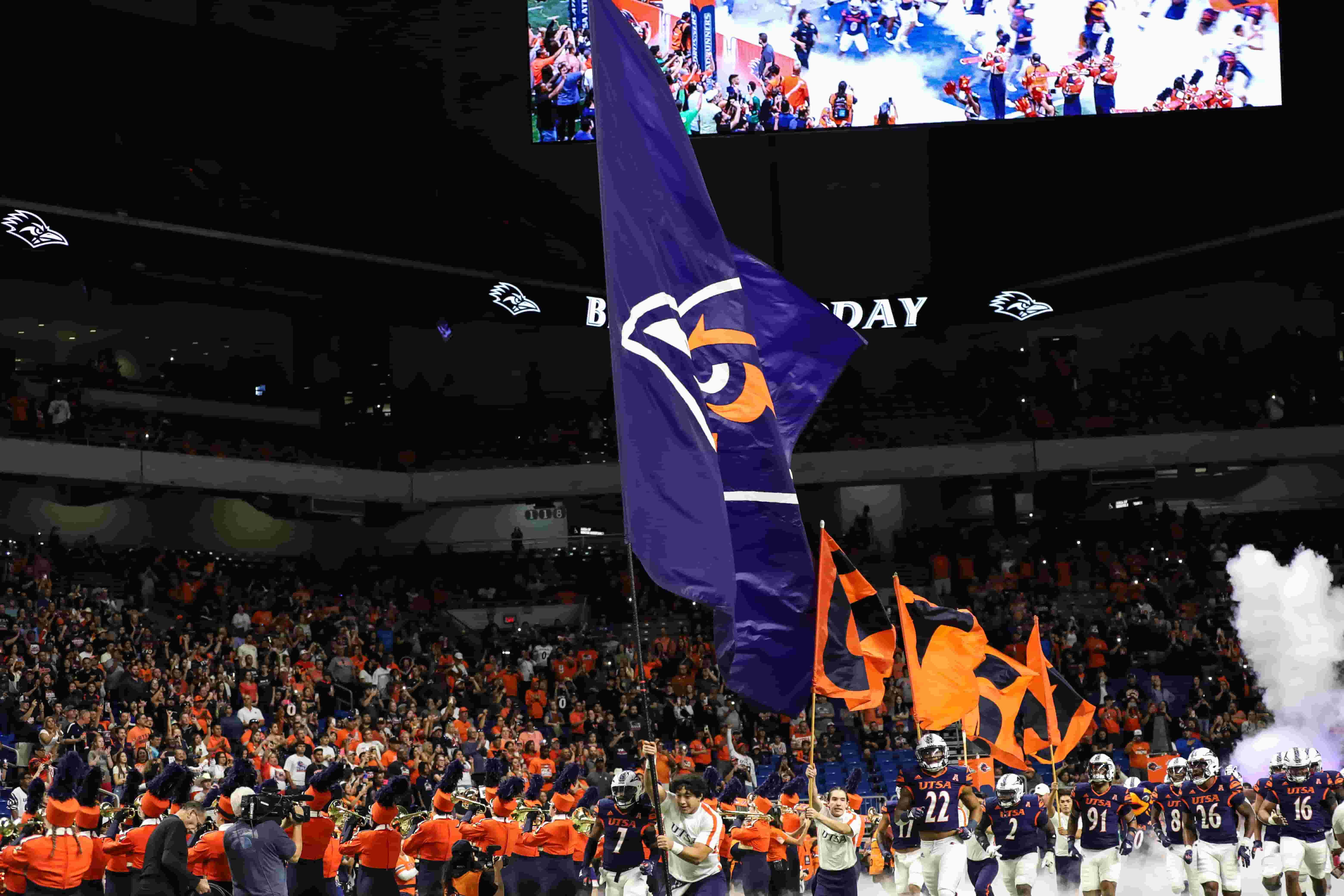 UTSA football players running on to field