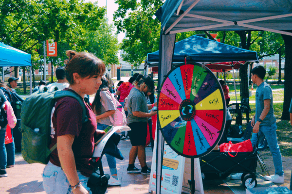 student playing a spinning wheel game at Birds Up DT