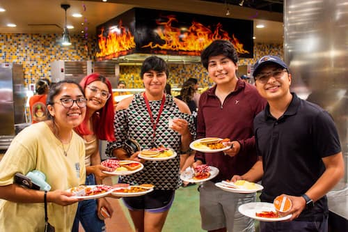 Students holding plates of food in Roadrunner Cafe