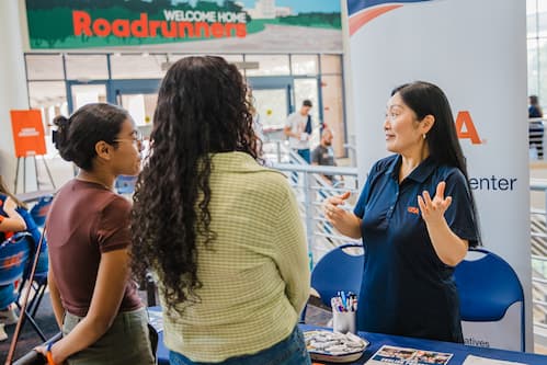 Woman explaining something to two girls